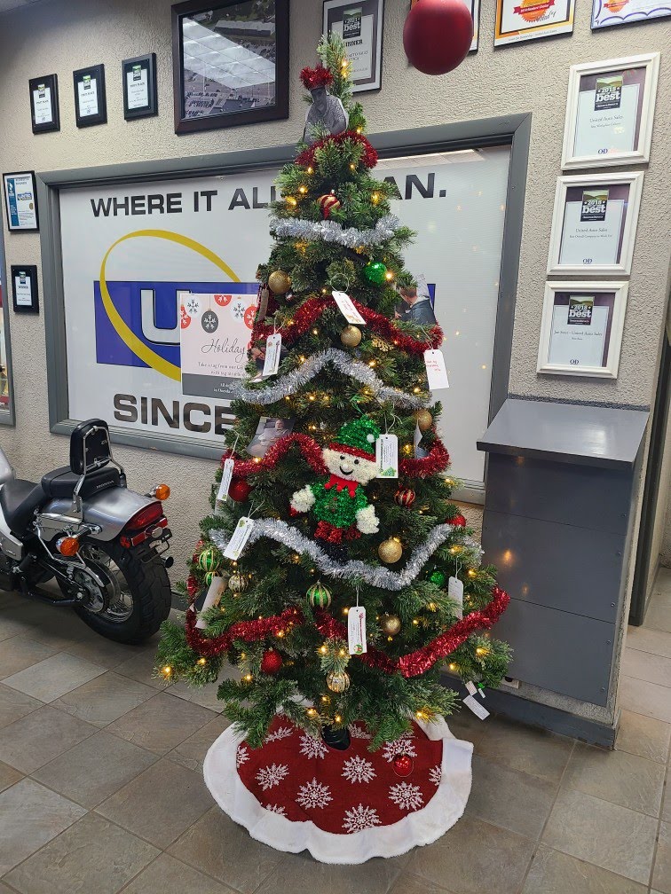 United Auto Sales of Utica Christmas Tree set up for Adopt-a-Family program through ICAN to benefit families in Utica, NY.