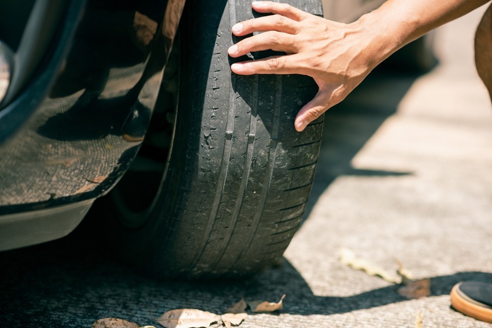 man checking tire tread