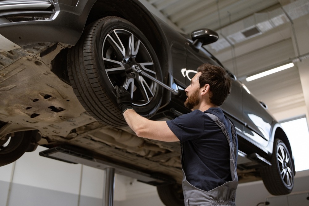 technician servicing a car tire