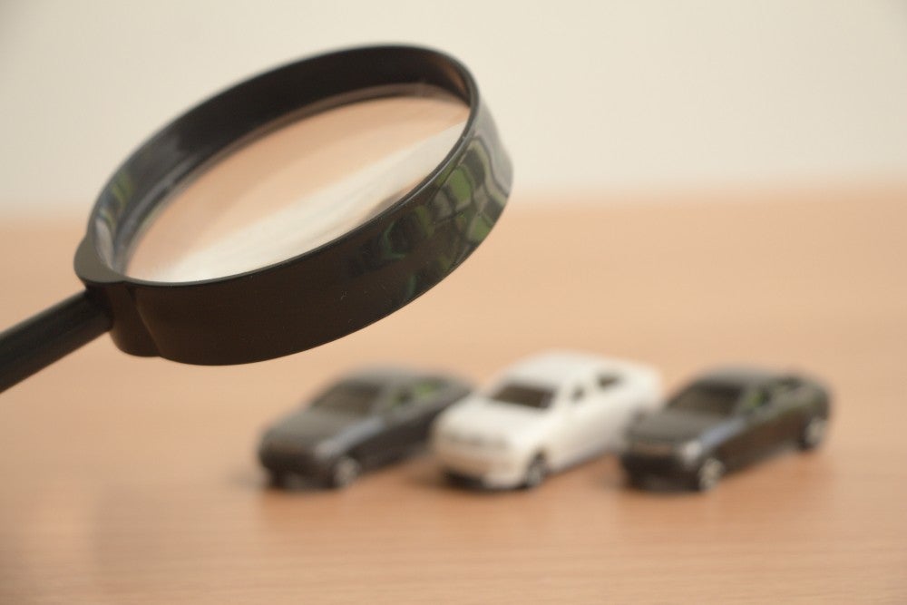 Toy cars under a magnifying glass