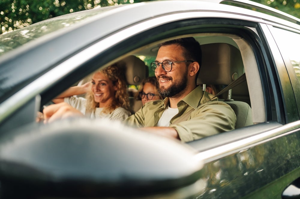 Family test driving a used car