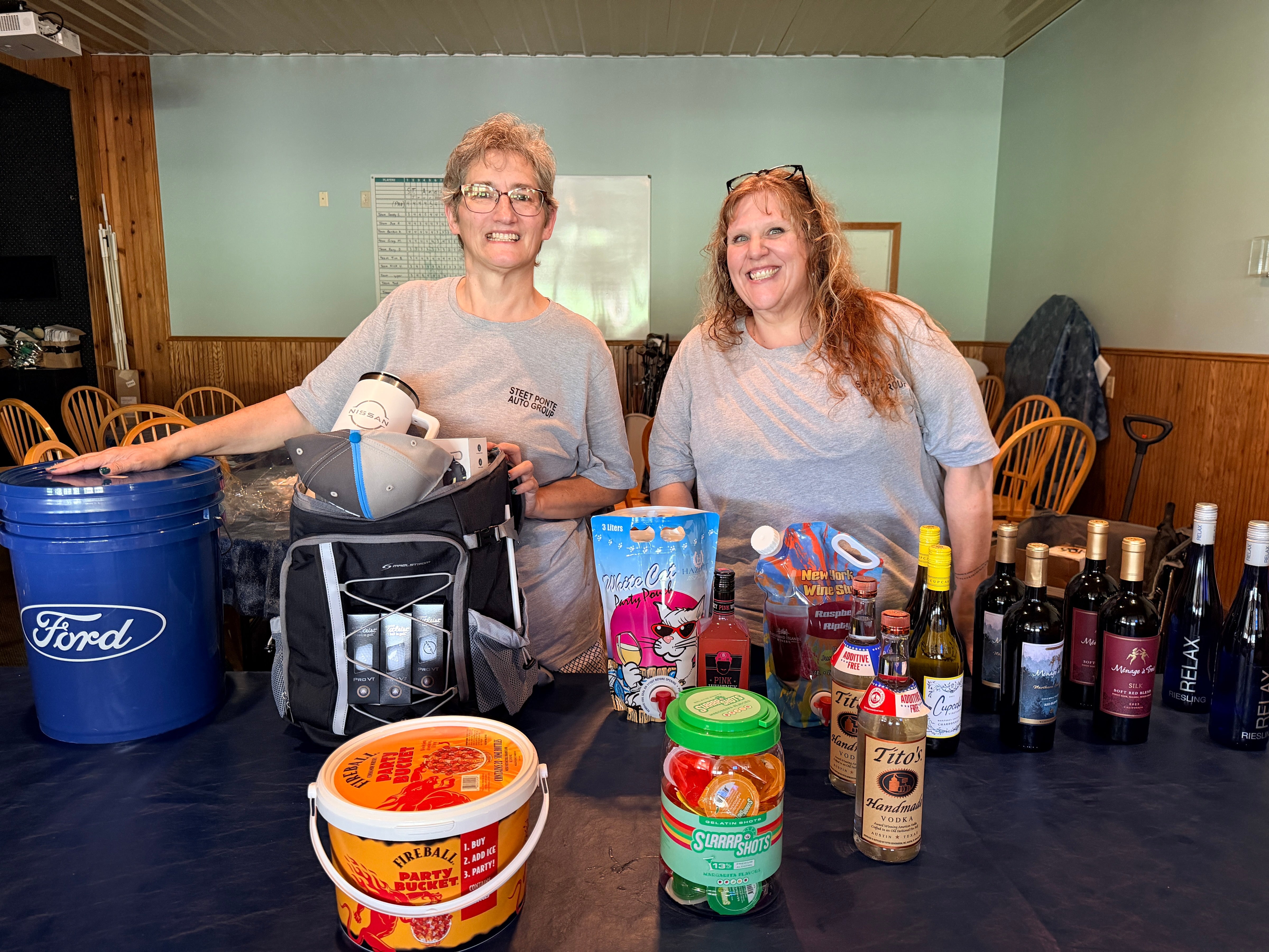 Barb Mazzotta and Valerie Rinaldi, Hosts of Steet Ponte Auto Group Golf Tournament Posing with Prizes from Tournament